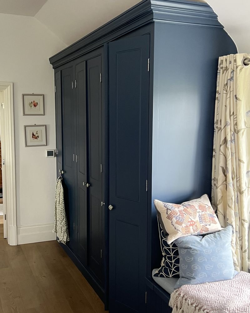 Fitted bedroom wardrobes hand-painted in navy blue