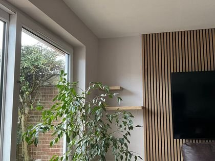 The same open plan living room looking towards the garden window