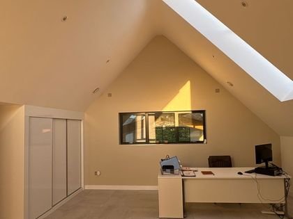The finished loft office with fitted cupboards and painted walls