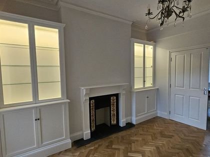 The dining room with restored fireplace, alcove units and parquet flooring
