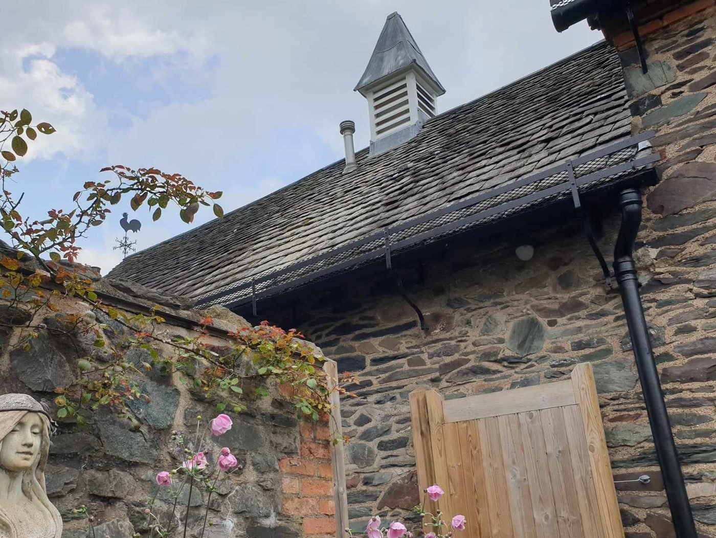 The lantern back in place on the stone building it belongs to