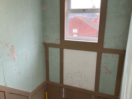Panelling set out and battened on the bare wall before filling