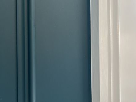 Close detail of the moulding profile on painted panelling
