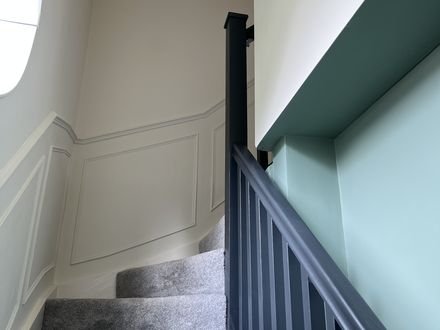 A panelled staircase with painted mouldings