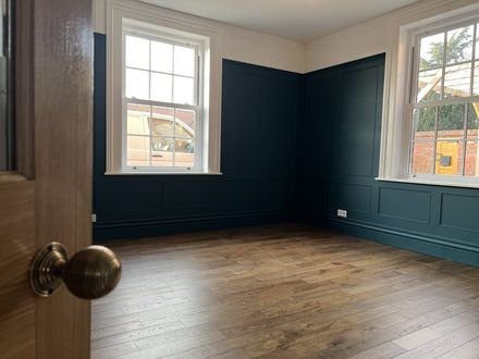 A finished navy panelled room with new timber flooring