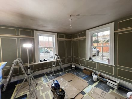 Panelling part-painted in navy with the floor sheeted up
