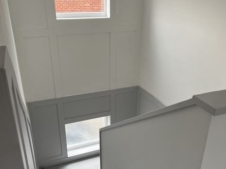 Panelling and mouldings carried up a staircase