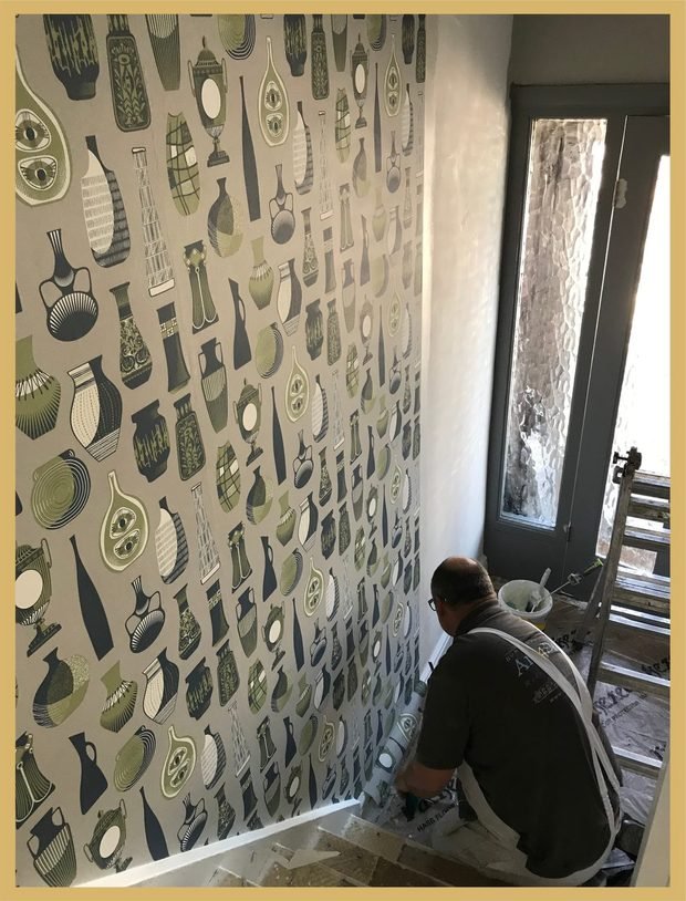Before and after: a hallway hung with a bold patterned paper
