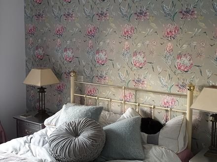 Floral wallpaper hung in a bedroom