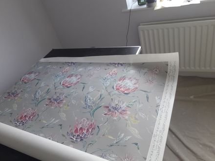 Wallpaper pasted out on the table before hanging